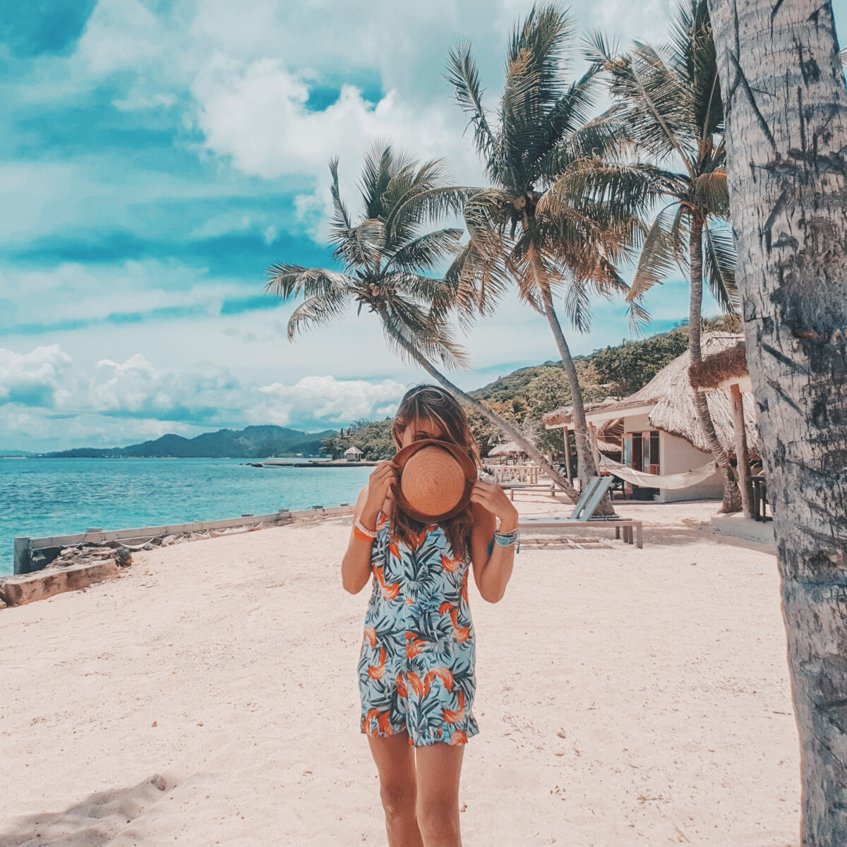 A white sand beach with turquoise waters, stretching along the edge of Fiji's Castaway Island.